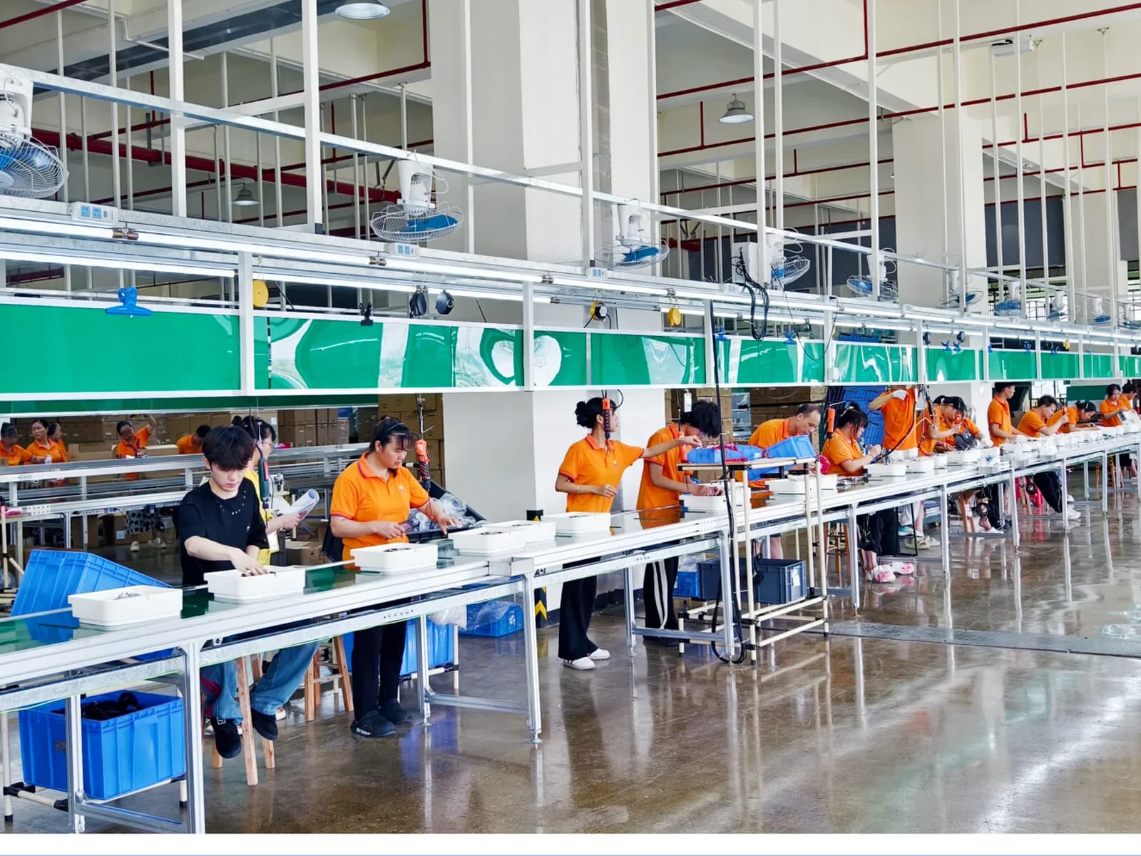 Workers assembling electric steamers on the production line
