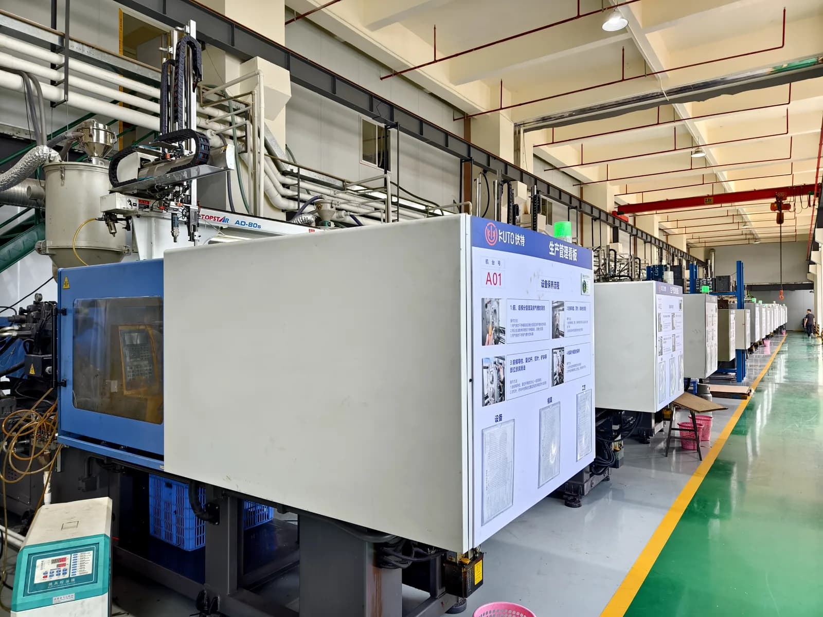 Rows of injection moulding machines running on the production floor